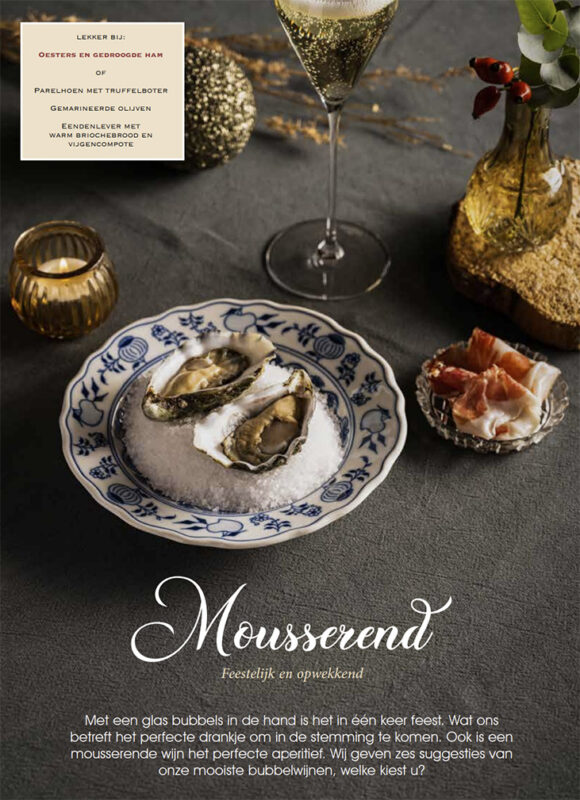 Champagne oesters en serranoham optafel met goudkleurige versiering